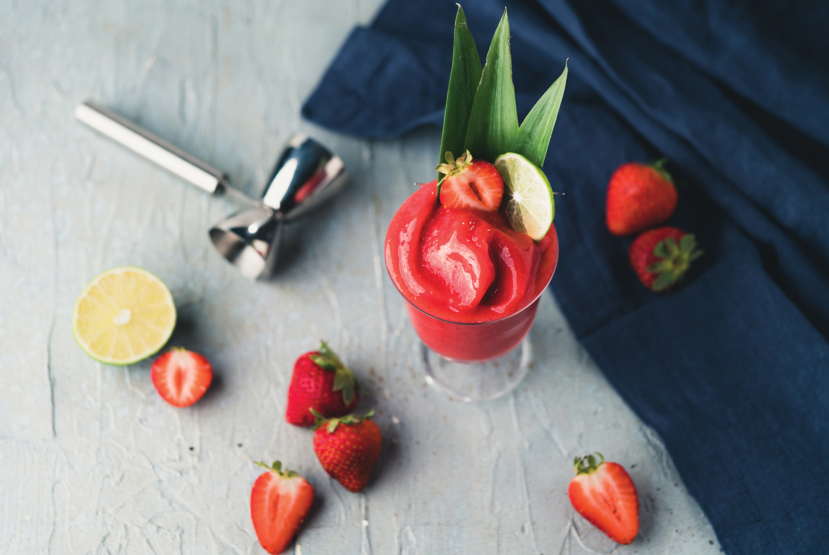 glass of strawberry daiquiri with lime