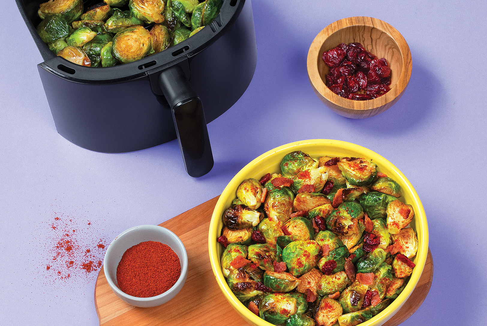 bowl of air fried brussels sprouts with paprika and cranberries