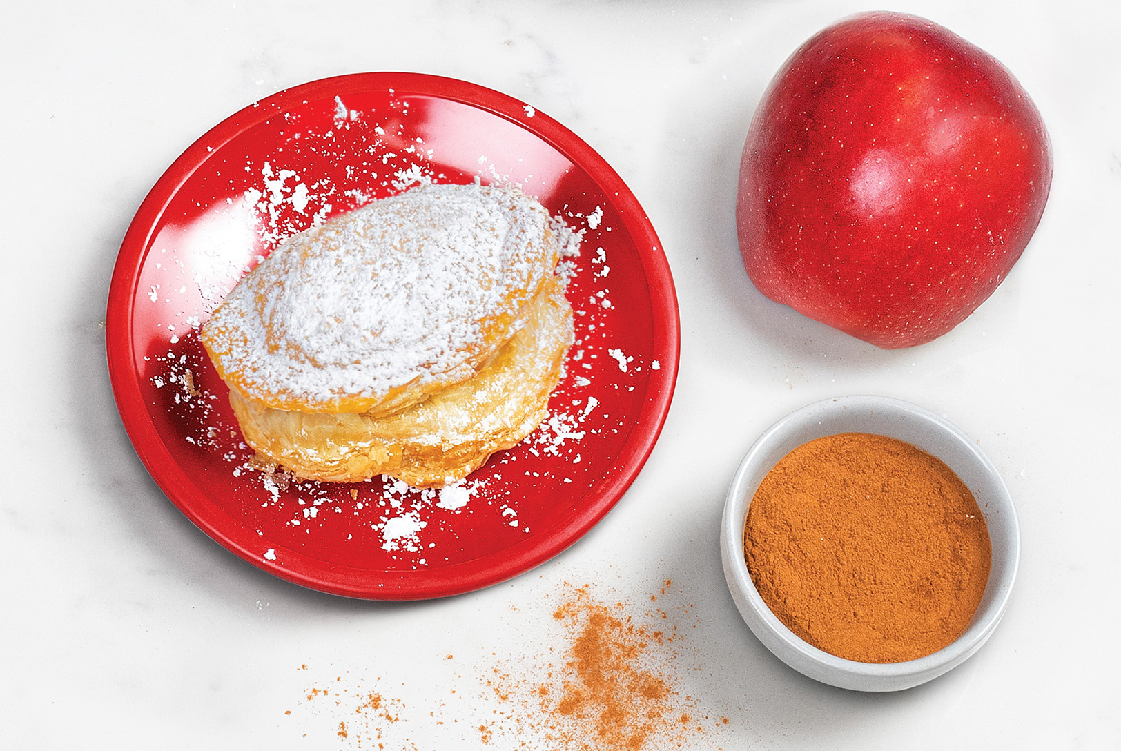 plate of cinnamon apple stuffed biscuit with powdered sugar