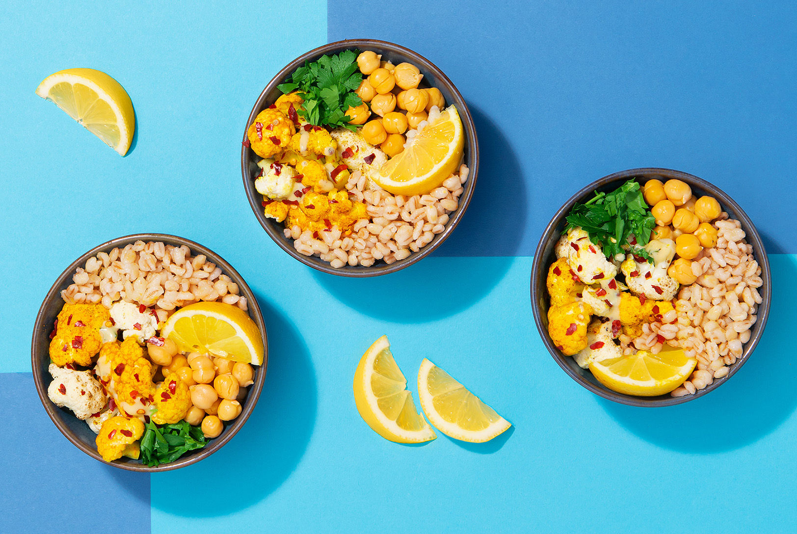 barley grain bowl with roasted cauliflower and lemon wedges