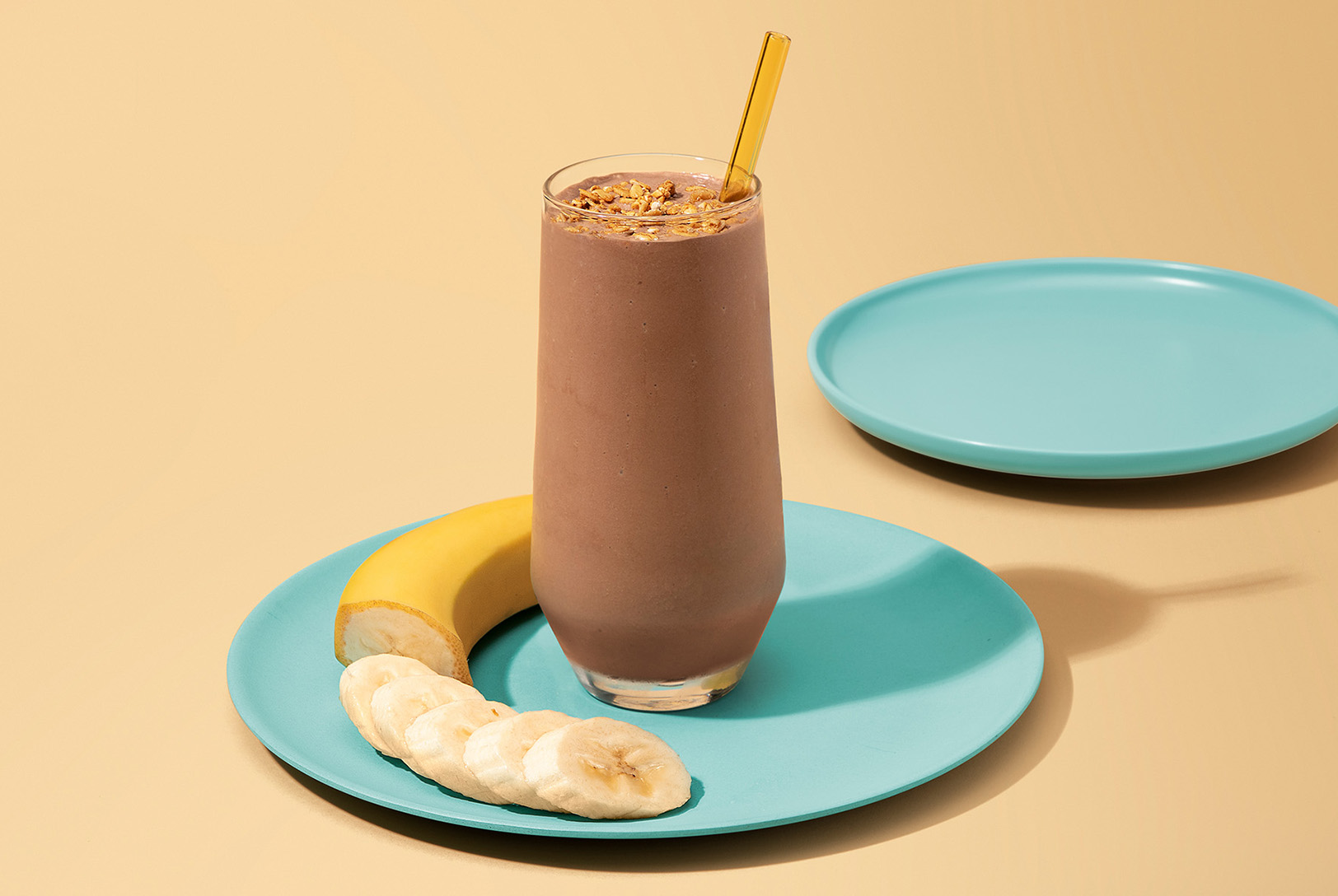 tall glass of blended coffee beverage with banana slices