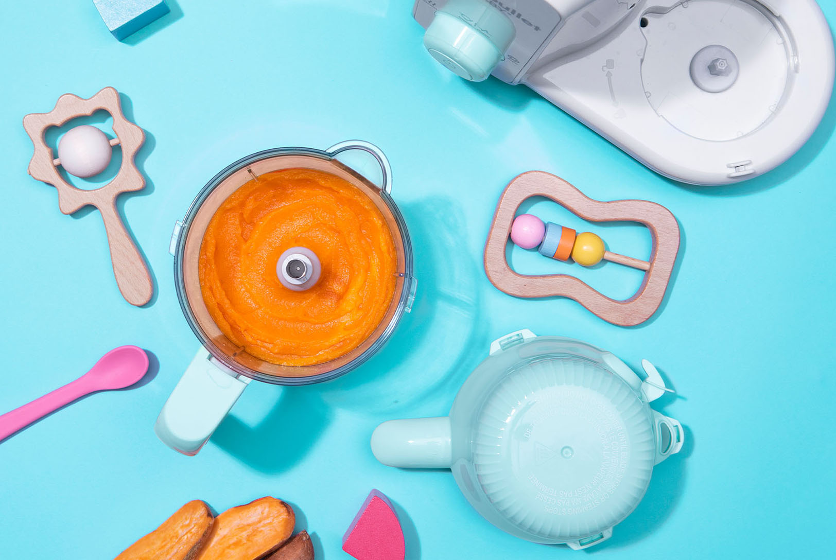 Blender with blended sweet potato and toys
