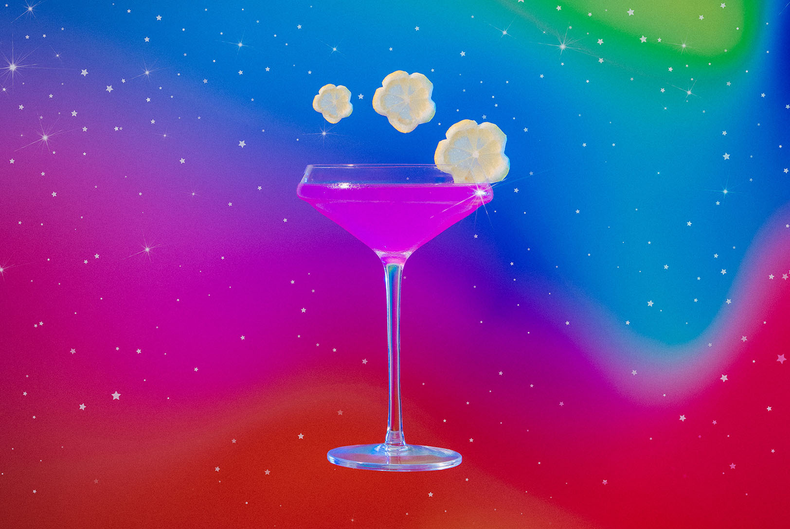 cancer inspired gin, lavender, and lemon cocktail surrounded by flowers in cosmic surroundings
