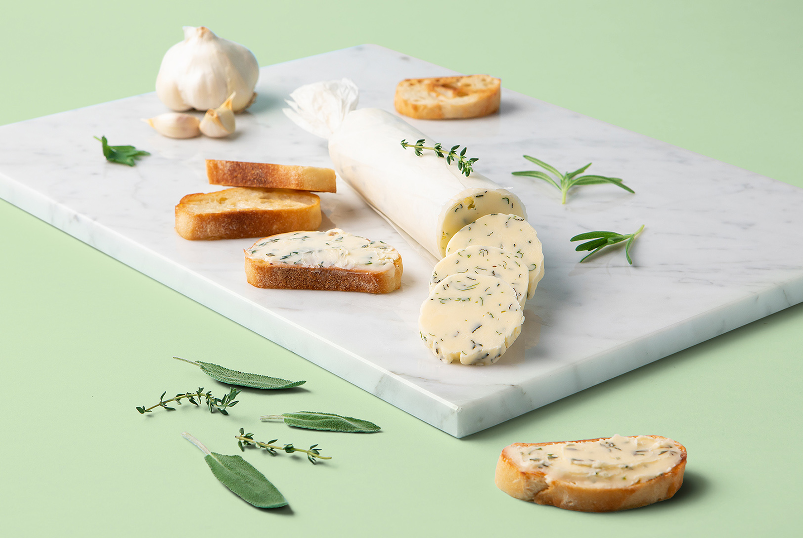 compound butter sliced on marble cutting board and French baguette