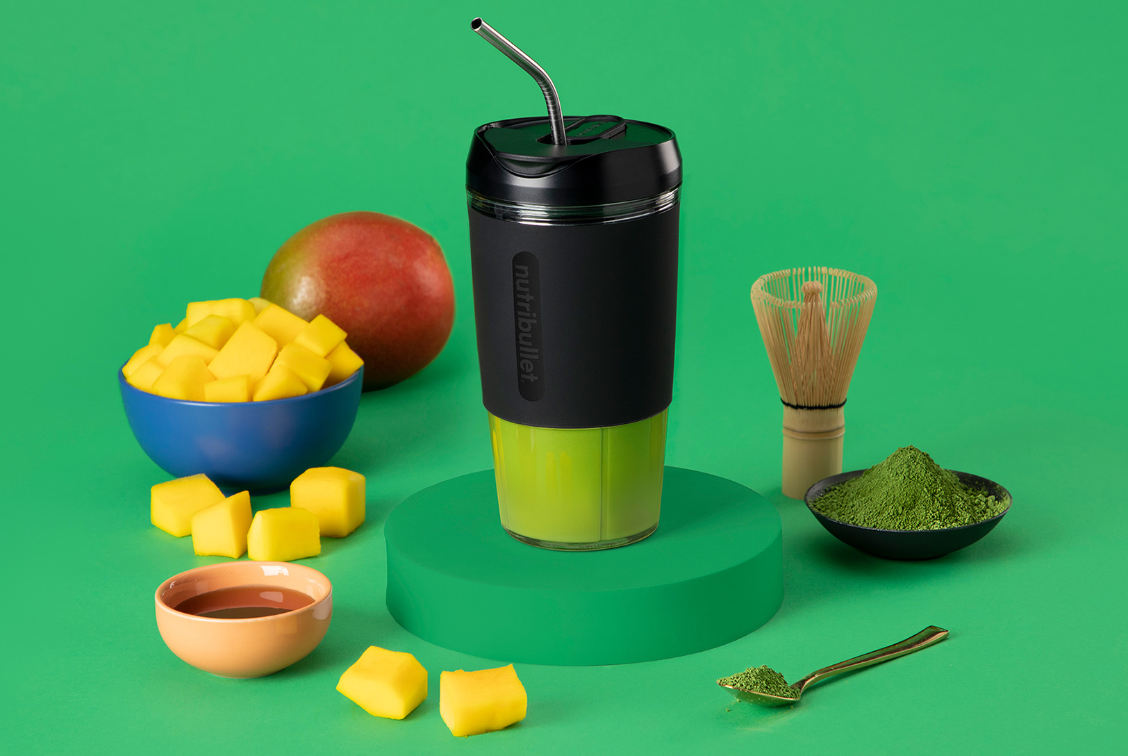 Black nutribullet Flip with mango, matcha powder, and agave