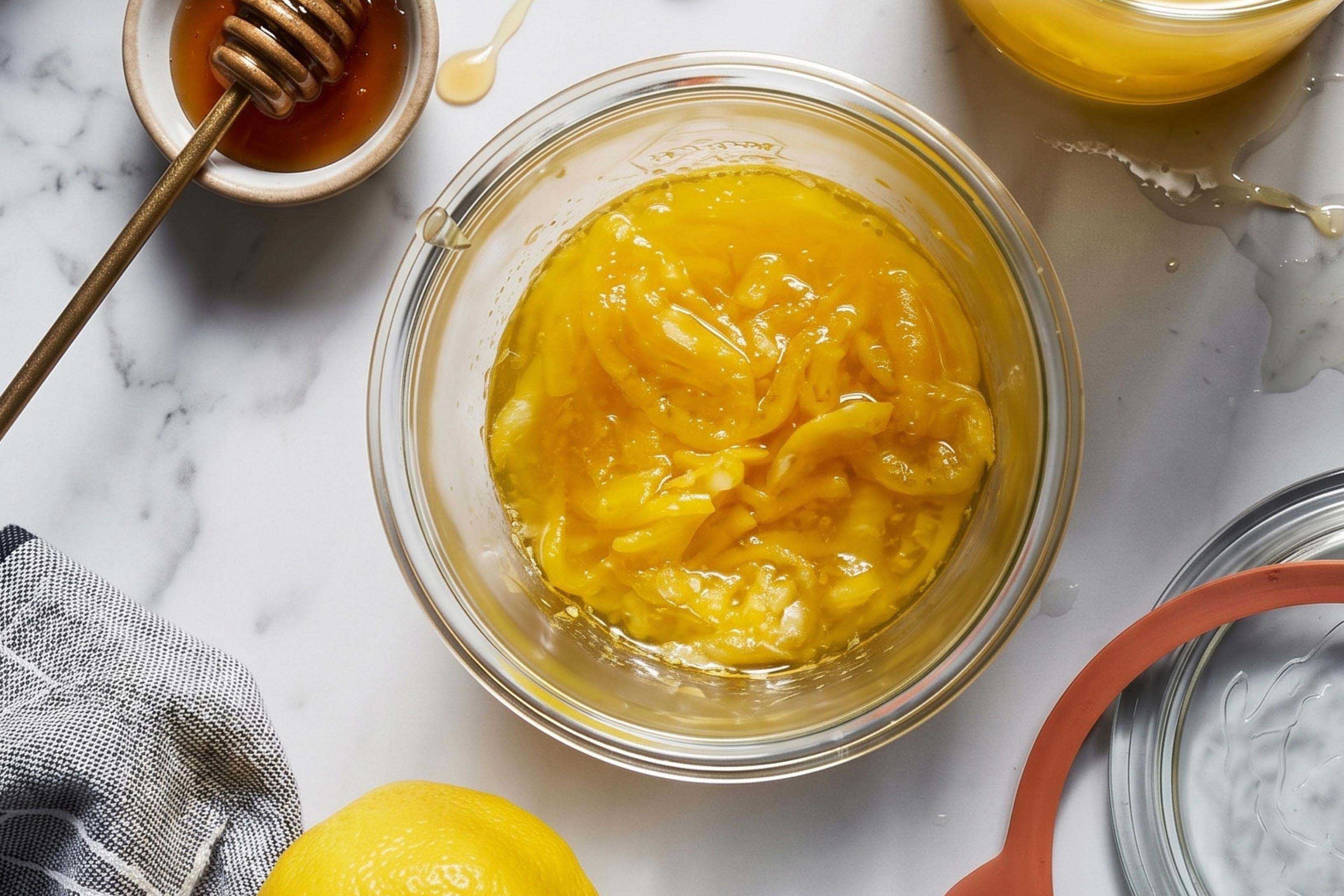 overhead image of homemade citrus tea concentrate surrounded by honey, lemon, and napkin