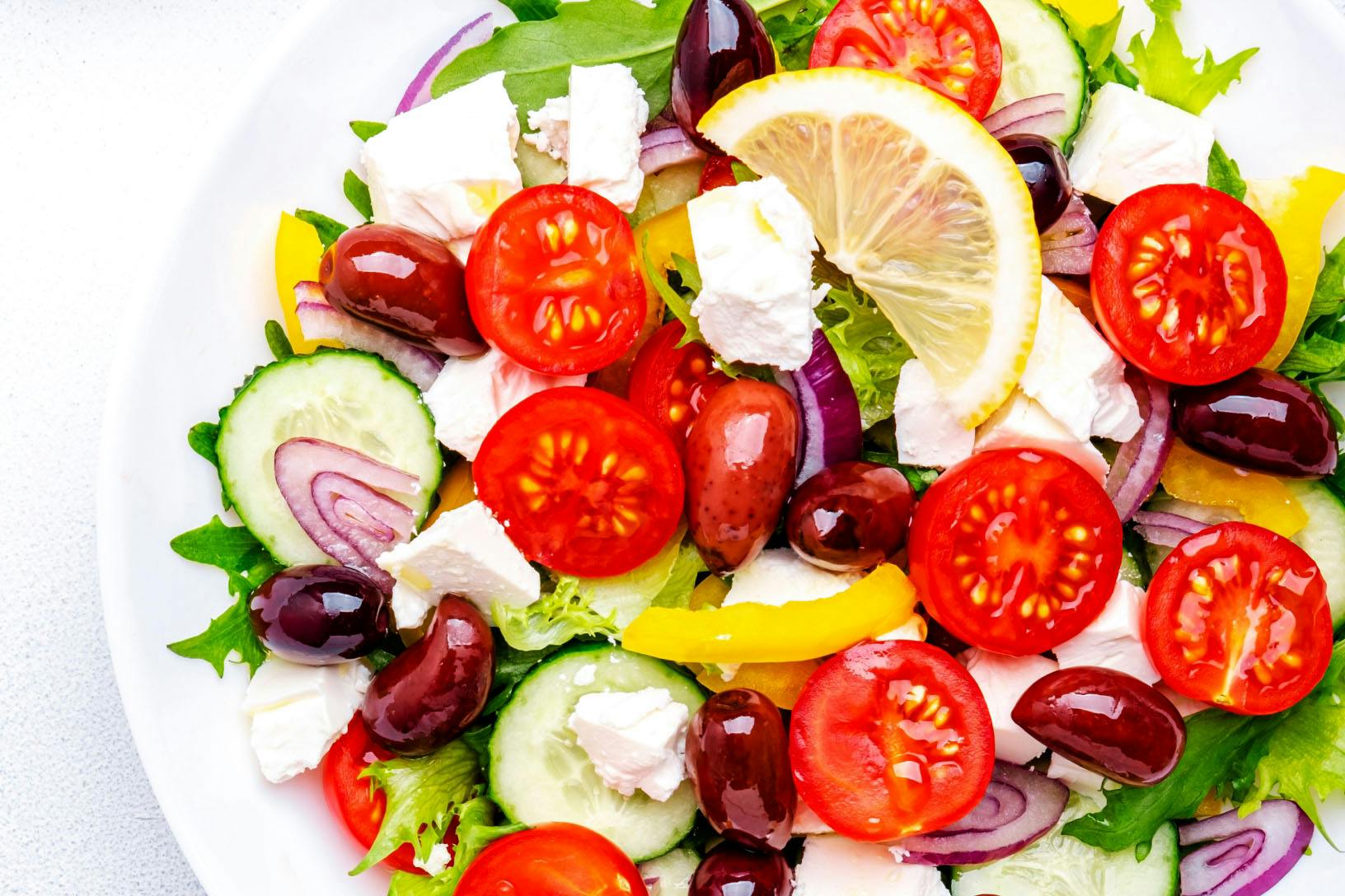 Classic Greek Salad - nutribullet Limitless Food Processor bowl of classic Greek salad made of tomatoes, cucumbers, olives, bell peppers, and feta cheese