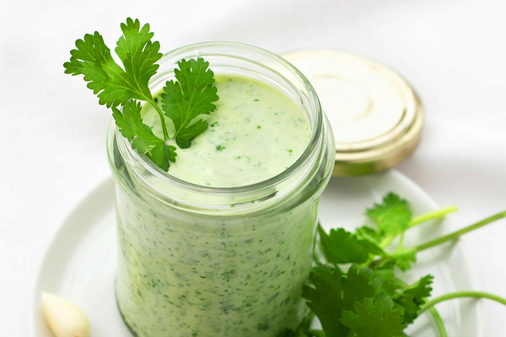 Creamy Herb Dressing - nutribullet Limitless Food Processor a clear jar of homemade dill dressing garnished with parsley