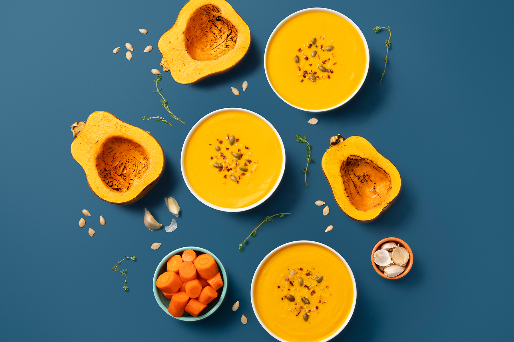 three bowls of squash soup with acorn squash