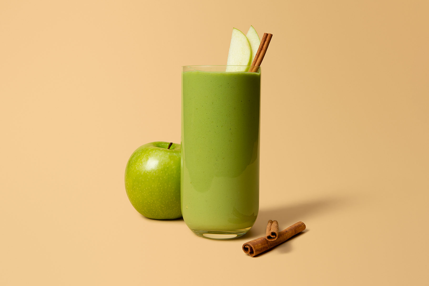Green apple smoothie with green apple and cinnamon sticks