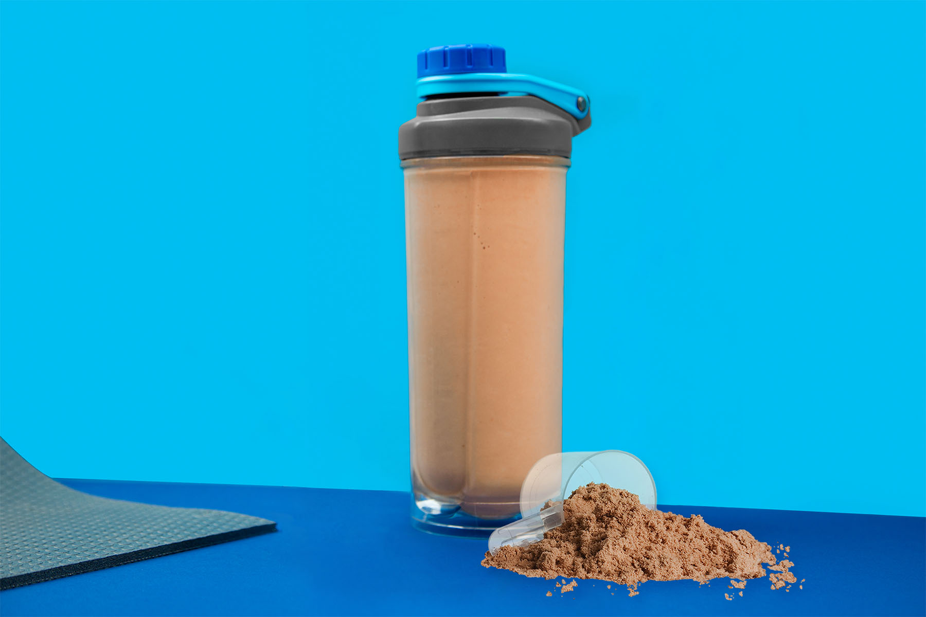 nutribullet cup and lid filled with a chocolate shake on a blue background
