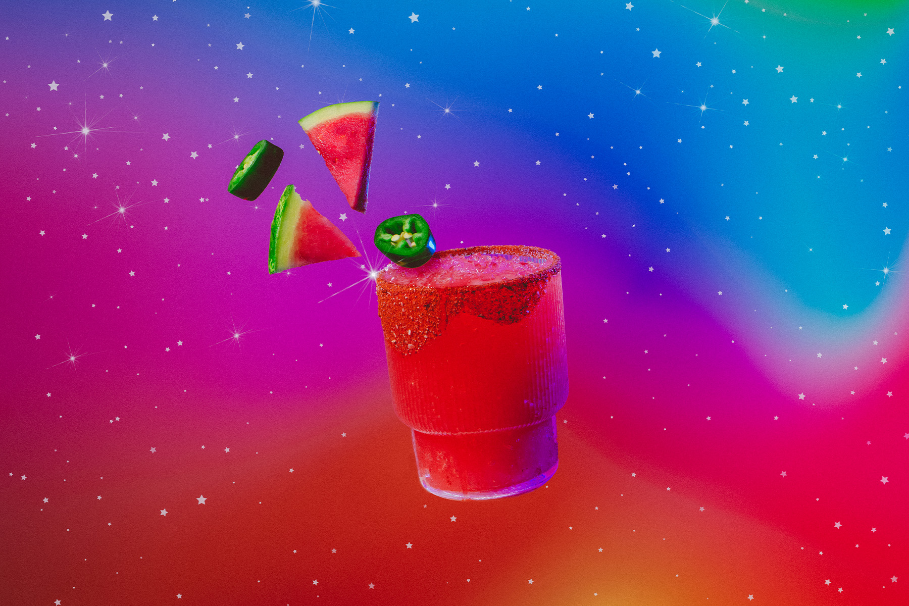 Aries zodiac inspired watermelon and lime cocktail with floating jalapeño slices and watermelon wedges in cosmic surroundings