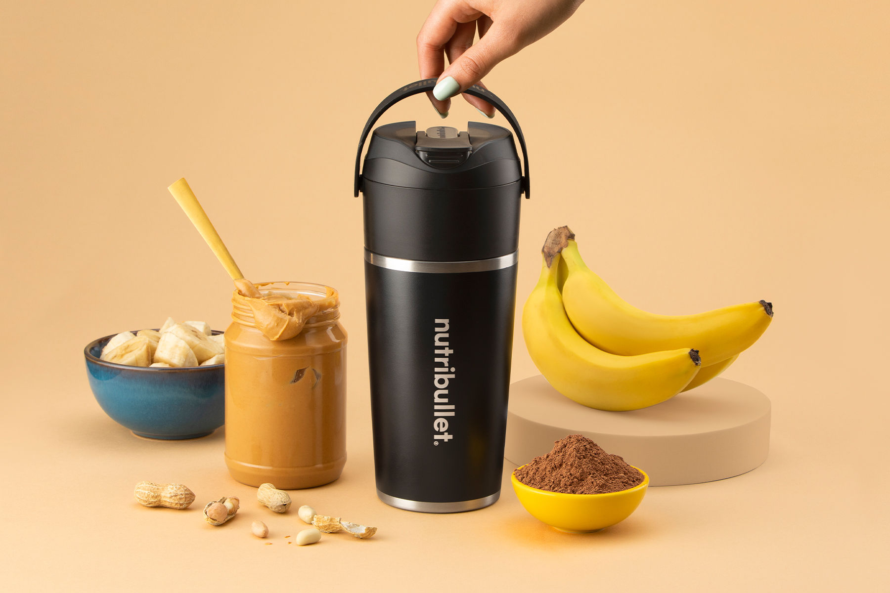 Black nutribullet Flip with peanut butter, bananas, and cacao powder