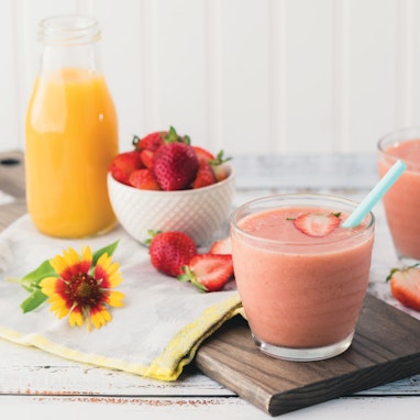 glasses of strawberry banana smoothie with orange juice
