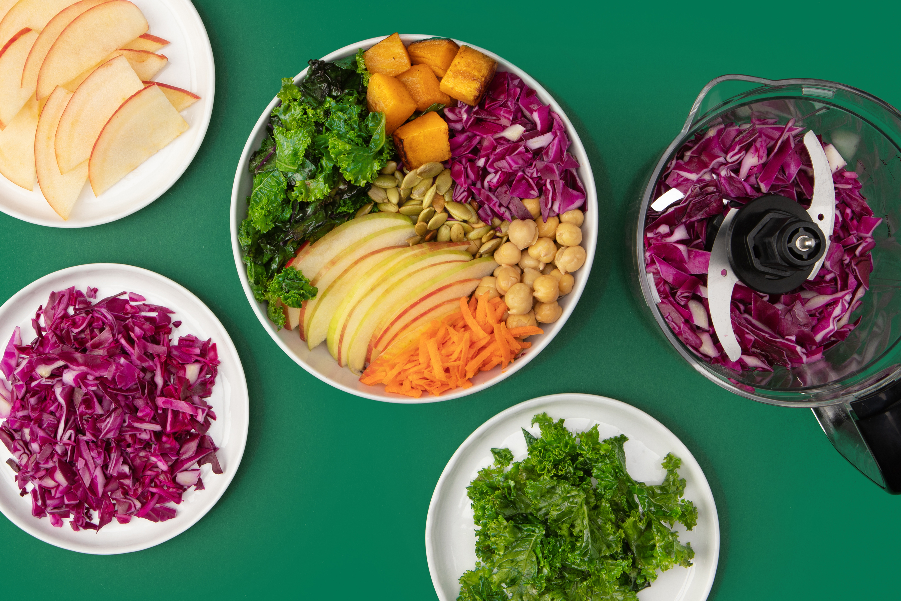 greens and grains bowl with butternut squash, apples, cabbage, carrots and chickpeas