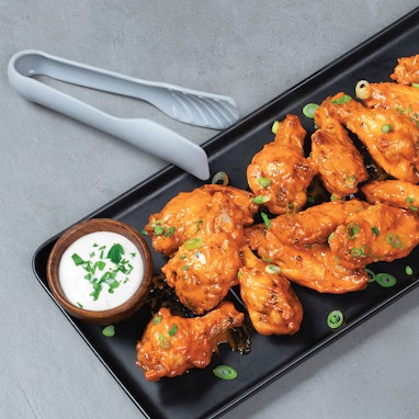 plate of crispy air fried chicken wings with ranch dipping sauce