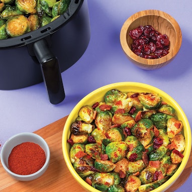 bowl of air fried brussels sprouts with paprika and cranberries