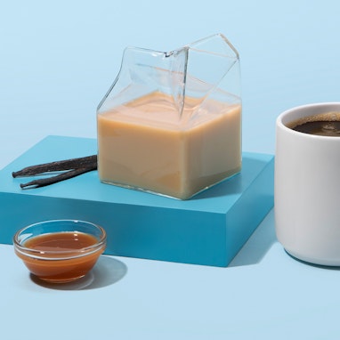 homemade caramel creamer next to mug of coffee
