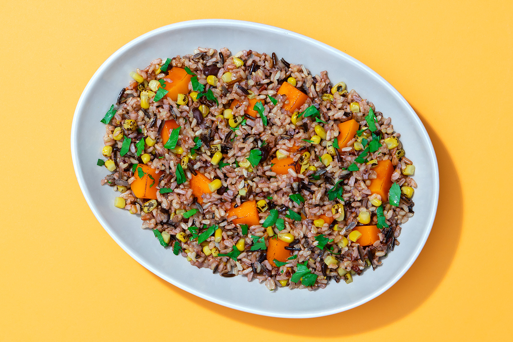 bowl of wild rice salad with corn, butternut squash and beans
