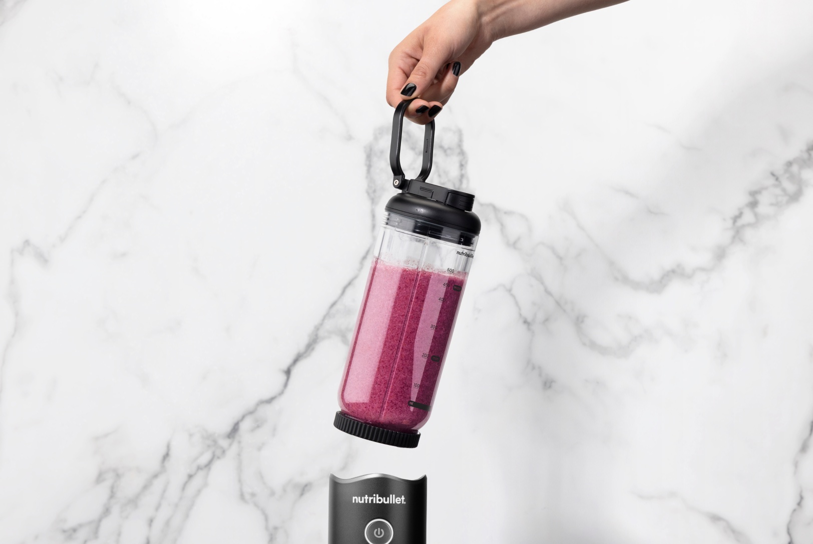 blueberry smoothie in portable blender - detached with marble background